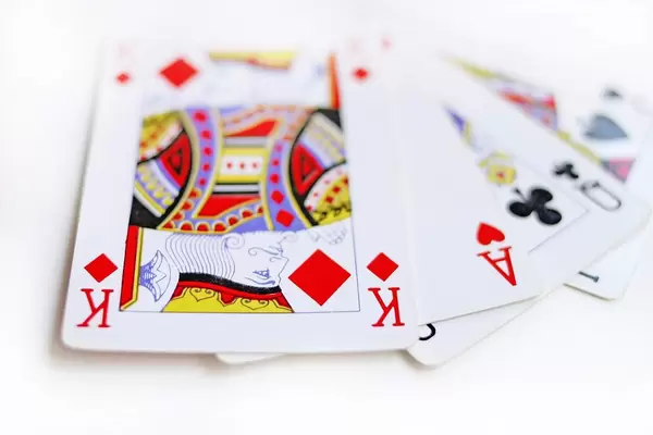 Playing Cards stacked as a Street on each other with King, Ace, Queen and Jack