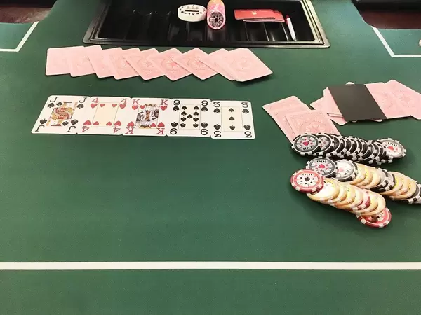 Playing poker: cards and chips on a green table