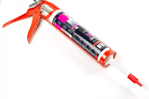 Plumbing silicone gun on white