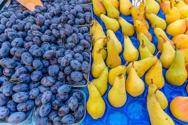 Plums and pears on marketplace