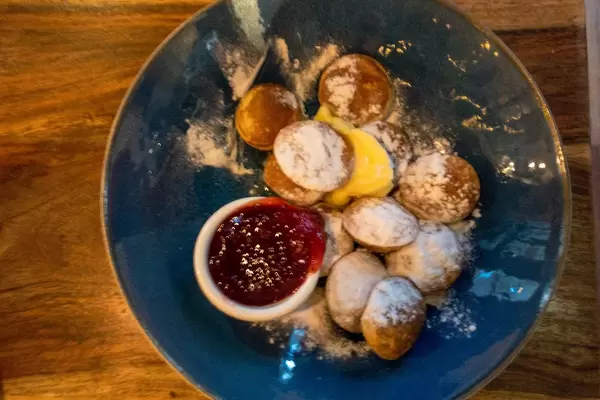 Poffertjes with powdered sugar and marmalade