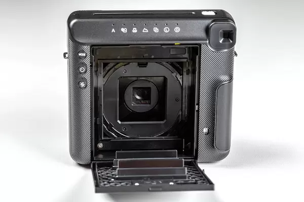 Polaroid camera with open back cover