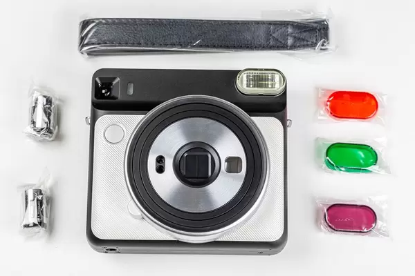 Polaroid with a set of accessories on a white background