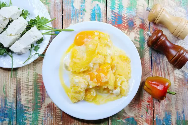 Polenta with cheese, cream and parsley. Vintage wooden background (Flip 2019)