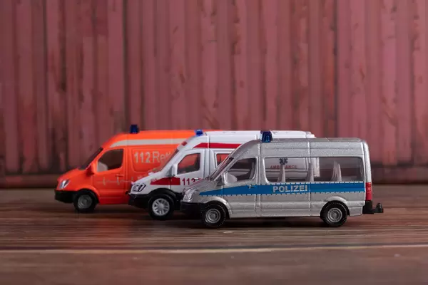 Police, firefighting and ambulance van parked in a line