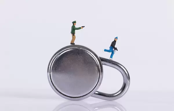 Policeman and robber with padlock on white background