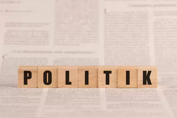Politik written with cubes on a newspaper