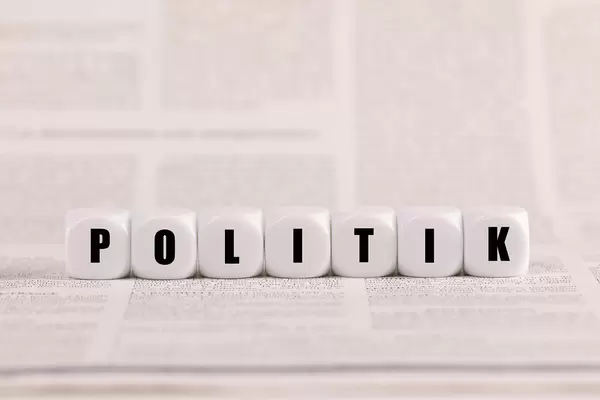 Politik, Würfel, Holzwürfel auf Zeitungspapier