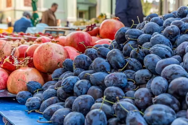 Pomegranate and plums on marketplace
