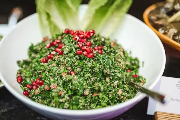 Pomegranate Salad with Mint Fresh Leaves in Glass Bowl