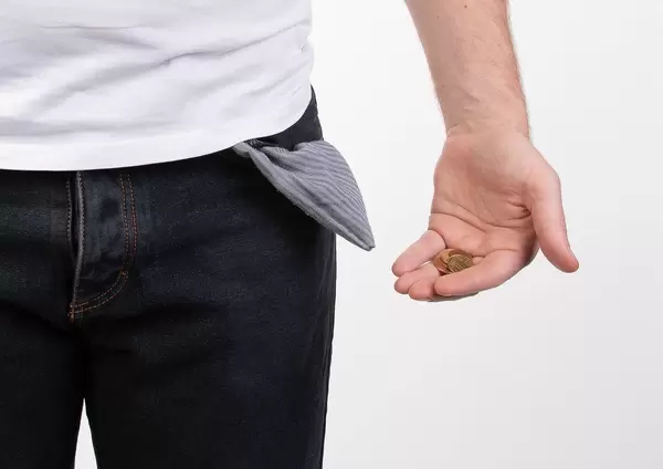 Poor man showing empty pocket
