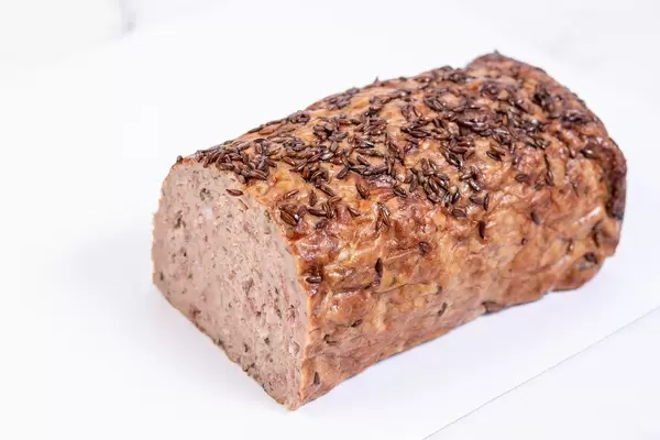 Pork and Chicken Meat Loaf with Cumin above white background