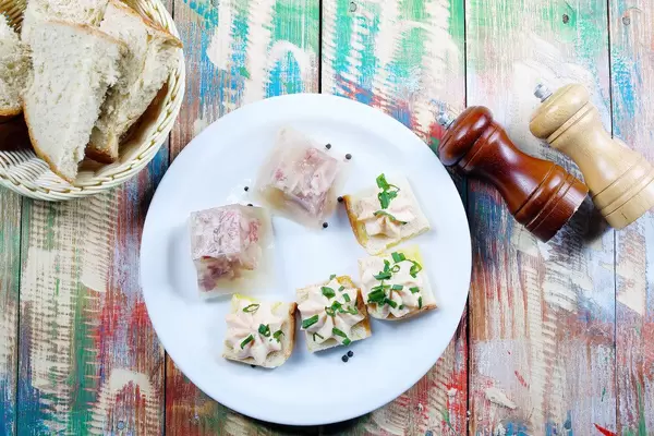 Pork jelly served with homemade bread, salt and pepper. Wooden vintage background (Flip 2019)