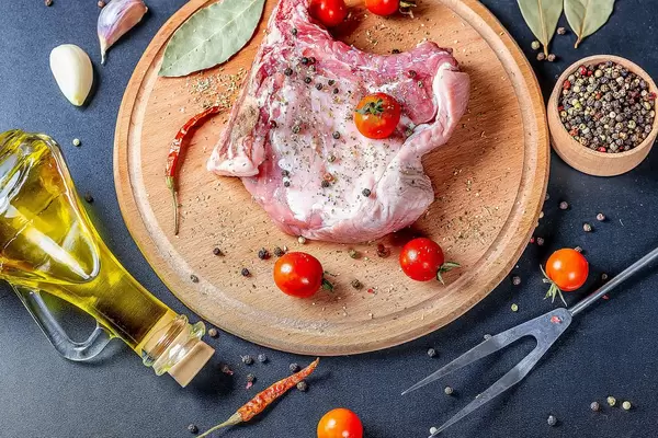 Pork meat with olive oil, cherry tomatoes and spices