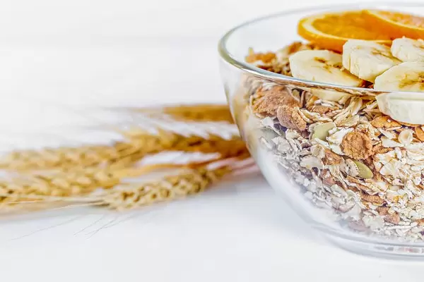 Porridge with cereals of different cereals in a glass plate with wheat spikelets