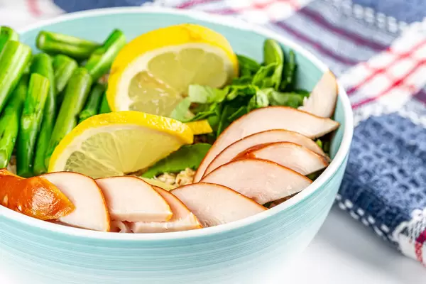 Porridge with vegetables and chicken fillet, close-up