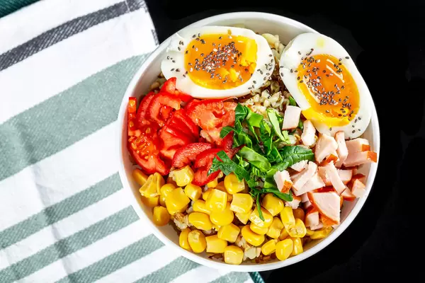 Porridge with vegetables, chicken and egg, top view