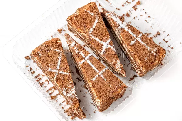 Portion pieces of napoleon chocolate cake in a plastic container
