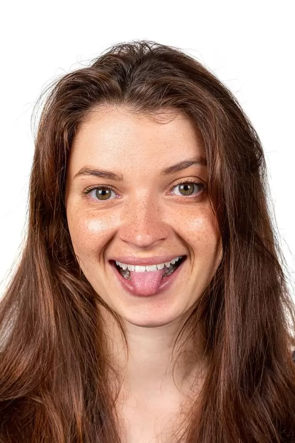 Portrait of a cheerful girl shows her tongue
