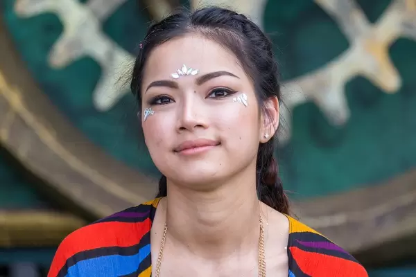 Portrait of a festival visitor at Tomorrowland with sparkling applications on her face