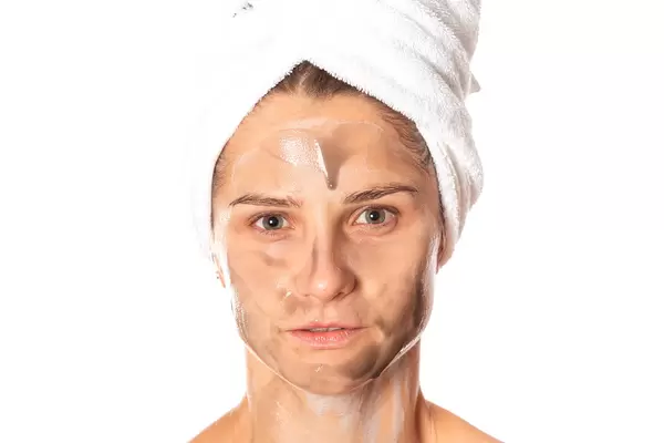 Portrait of a girl caring for her face, a cosmetic mask is applied to the skin