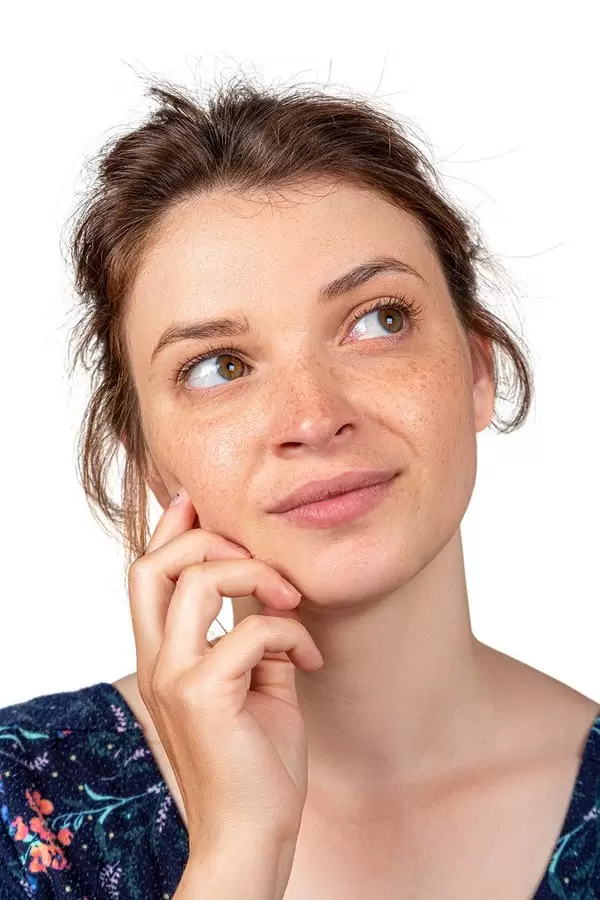Portrait of a girl with freckles without makeup