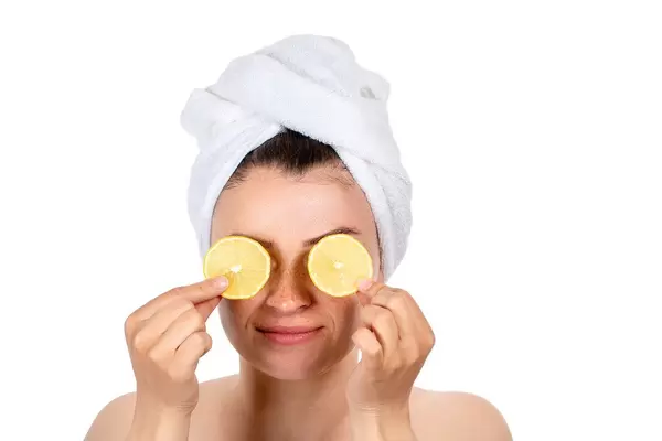 Portrait of a girl with lemon slices in front of her eyes