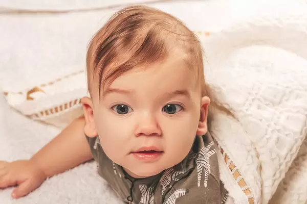 Portrait of a little boy lying on his stomach