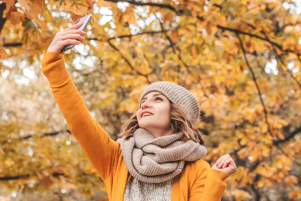 Portrait of a smiling girl looking at the screen of her smartphone