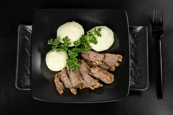 Potato balls with liver and fresh parsley, top view