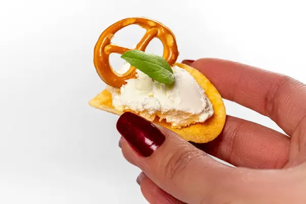 Potato chips with cheese in a female hand (Flip 2019)