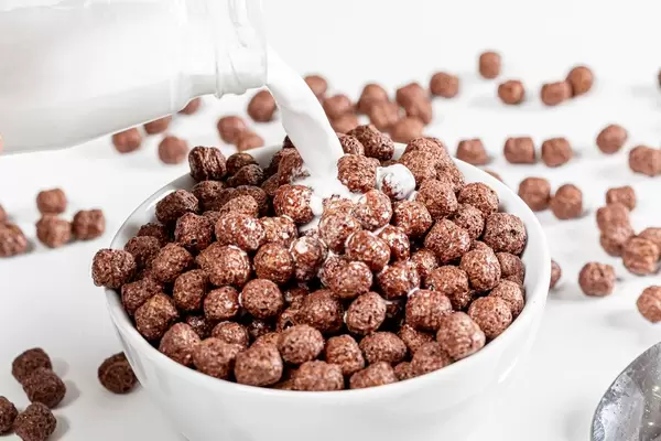 Poured milk from a bottle into a bowl with a chocolate Breakfast