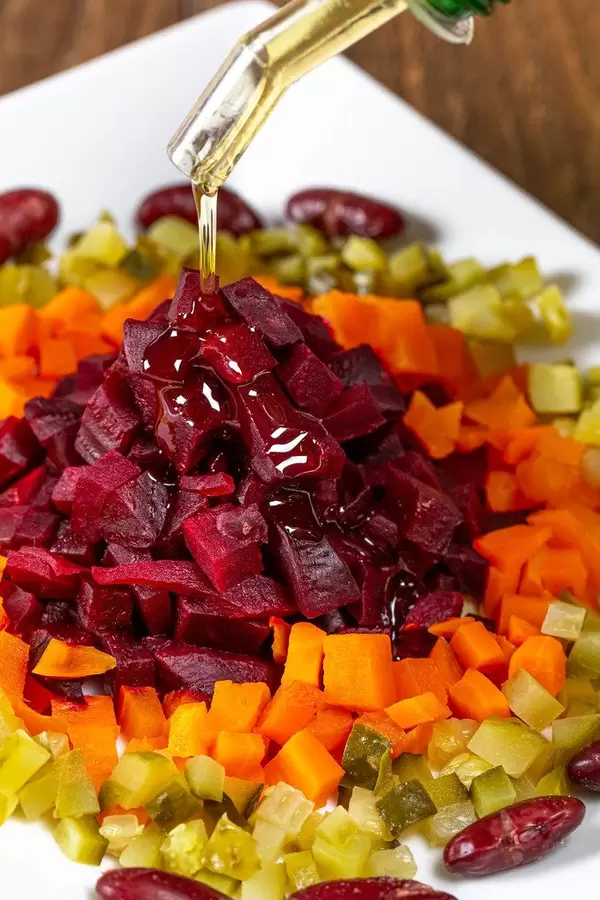 Poured oil from a bottle into a vegetable salad (Flip 2019)