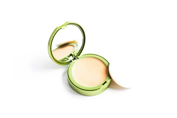 Powder foundation make up with mirror on white background