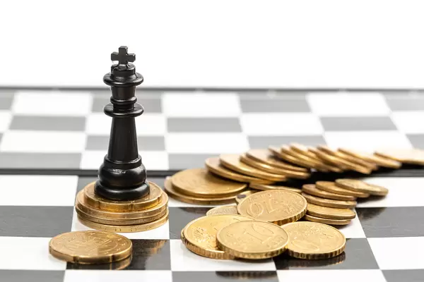 Power of the money concept - chess king standing on the money