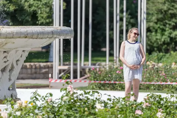 Pregnant woman posing for photo in Gorky Park