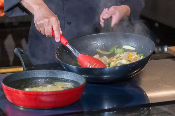Preparing asian food during cooking show with live audience