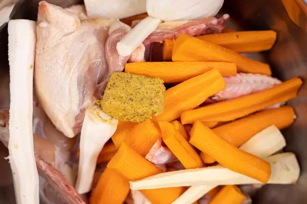 Preparing Chicken Soup for cooking with raw vegetables and chicken meat