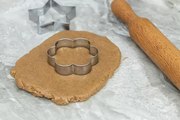 Preparing Christmas cookies with cookie templates