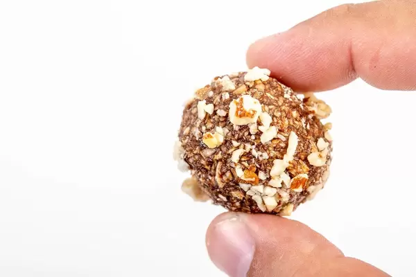 Preparing heatly Oatmeal cookie balls with Almonds in the hand (Flip 2019)