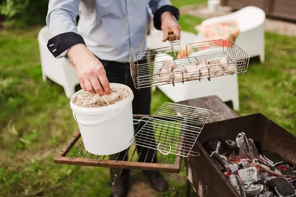 Preparing Meat With Onions On The Grill