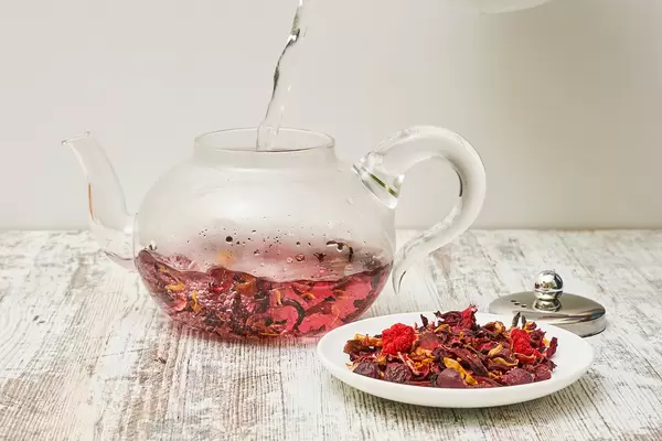 Preparing red tea and dry tea leaves on the plate