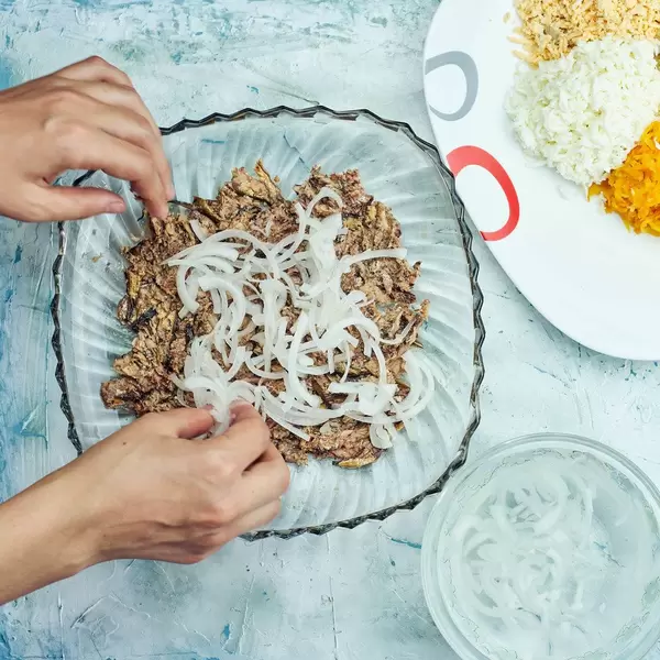 Preparing salad with smoked sprats