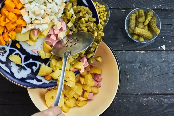 Preparing traditional Russian New Year's Day salad - Olivier