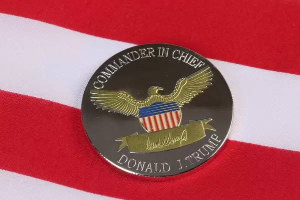 President Donald Trump coin against US flag