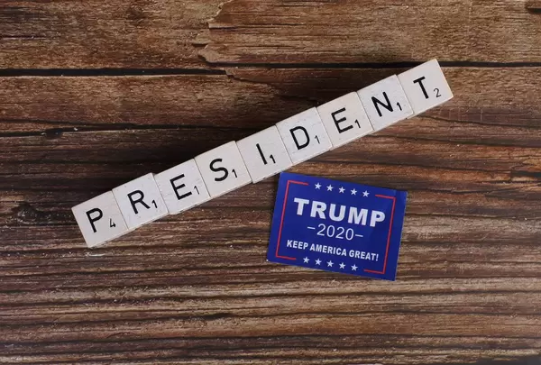 President written on wooden blocks and Trump 2020 campaign sticker