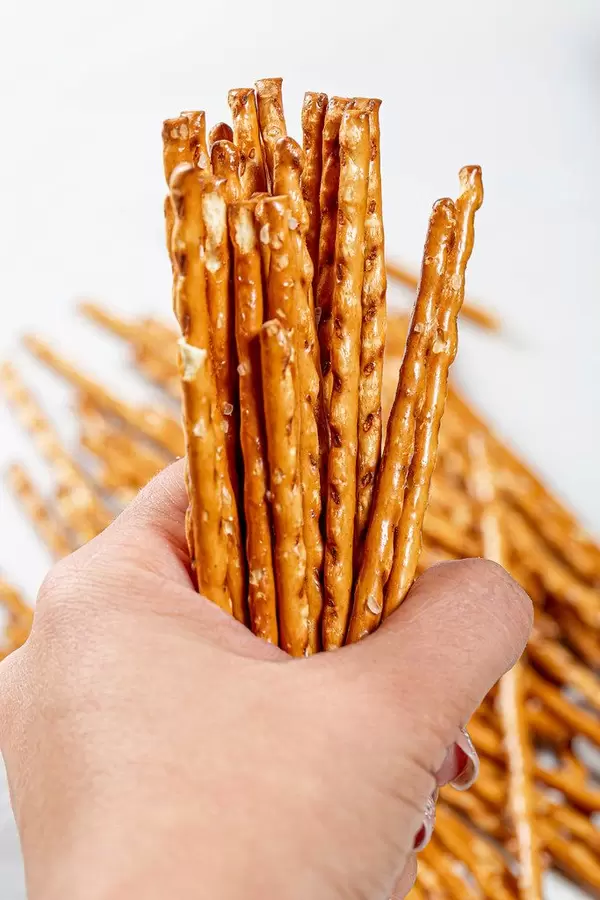 Pretzel sticks close-up in a woman's hand