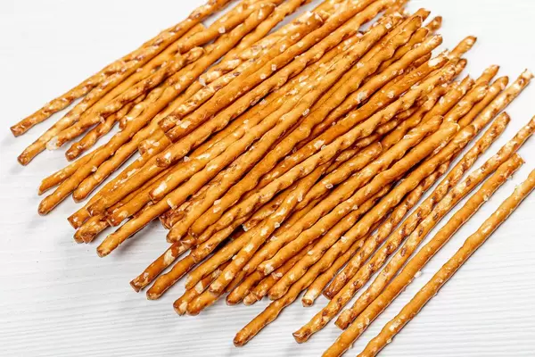 Pretzel sticks on white wood background (Flip 2019)