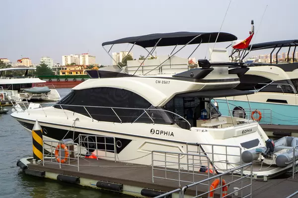 Private Yacht with Small Motorboat and Sundeck at the Harbour of Vinhomes Central Park and Apartment Buildings in Ho Chi Minh City, Vietnam
