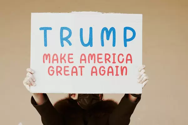 Pro-Trump US citizen holds a placard with words - Make America Great Again